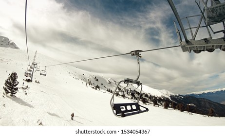 Aerial Ski Lift Pov. Skiing At Pirin At The Slope In Bansko Resort, Bulgaria, Slow Motion