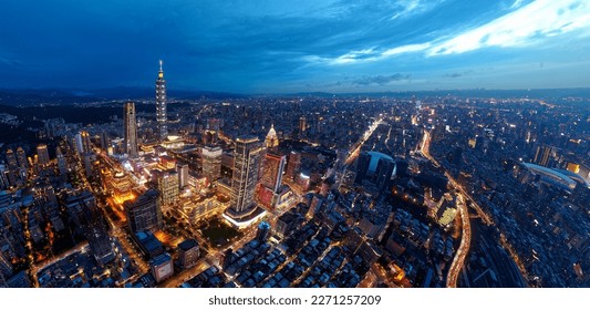 Aerial skyline of Downtown Taipei at nightfall, the vibrant capital city of Taiwan, with 101 Tower standing out among the skyscrapers in Xinyi Financial District and city lights dazzling at blue dusk - Powered by Shutterstock