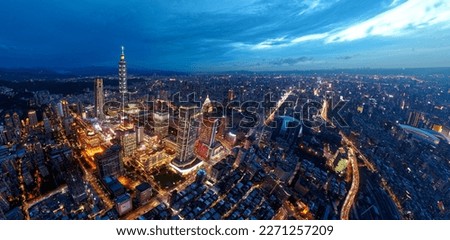 Aerial skyline of Downtown Taipei at nightfall, the vibrant capital city of Taiwan, with 101 Tower standing out among the skyscrapers in Xinyi Financial District and city lights dazzling at blue dusk 商業照片 © 