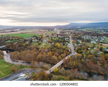 Aerial Of The Small Town Of Elkton, Virginia In The Shenandoah Valley With Mountains In The Far Distance