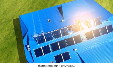 Aerial. Solar Panels On The Roof Of The House With Blue Tiles. View Above From Drone.