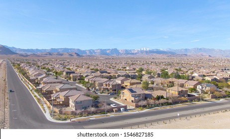 AERIAL Spectacular shot of Las Vegas suburbs sprawling across the Mojave desert. Real estate properties fill up the arid terrain leading up to the city of Las Vegas. Stunning shot of American suburbia