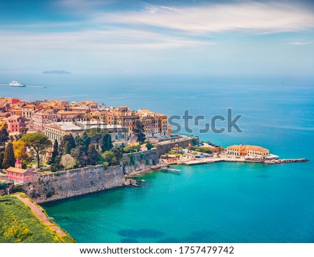 Aerial spring cityscape of capital of Corfu island. Colorful building  at the morning in Kerkira town. Amazing  seascape of Ionian Sea, Greece, Europe. Traveling concept background.
