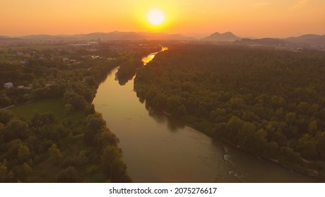 AERIAL: Stunning Wide River With Tributary At Magical Golden Light Sunset