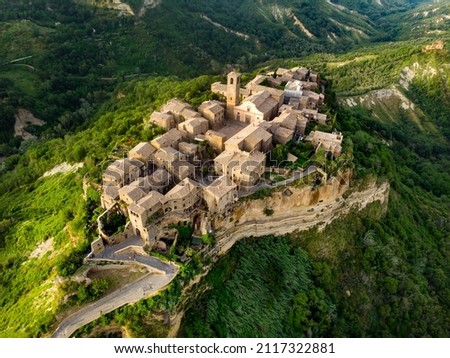 Aerial summer evening view of famous Civita di Bagnoregio village, located on top of a volcanic tuff hill overlooking the Tiber river valley. The place has Etruscan and Medieval origins.