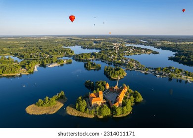 Aerial summer sunny sunset view of Trakai Island Castle and hot air balloons, Lithuania - Powered by Shutterstock