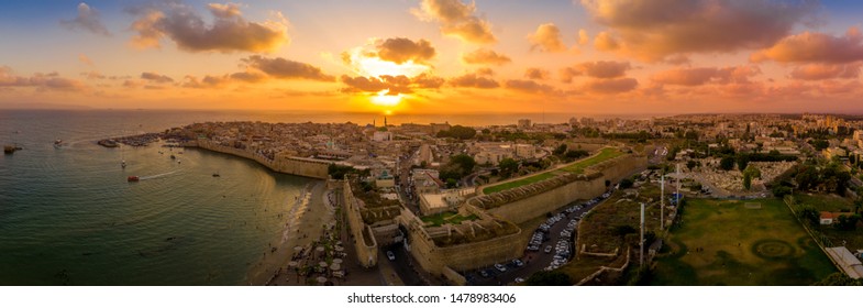 Aerial summer sunset view of Acco, Acre, Akko medieval old city with green roof Al Jazzar mosque and crusader palace, city walls, arab market,  knights hall, crusader tunnels,  in Israel