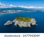 Aerial and summer view of Beomseom Island with rock cliff and columnar joints on the sea against Halla Mountain near Seogwipo-si, Jeju-do, South Korea
