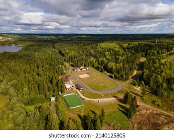 Aerial summer view of football field in forest camp