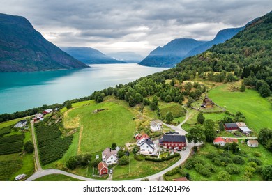 Aerial summer view of traditional Urnes rural village with Unesco Stave church in Lustrafjorden in Norway - Shutterstock ID 1612401496