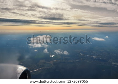 aerial sunrise over airplane wing in flight
