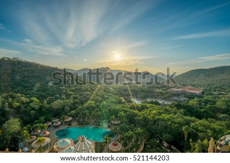 Aerial sunrise scene of suncity in South Africa with flare and ray from the sunrise 