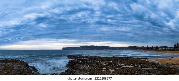 Aerial sunrise seascape with cloud covered sky and tessellated rock platform at North Avoca Beach on the Central Coast, NSW, Australia. - Shutterstock ID 2223289277