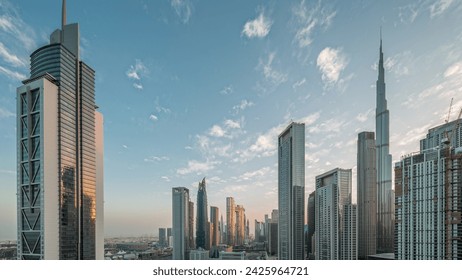 Aerial sunrise view of Dubai Downtown skyline with many towers night to day transition timelapse. Business area in smart urban city. Skyscrapers and high-rise buildings from above early morning, UAE. - Powered by Shutterstock