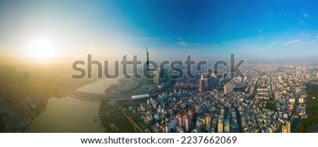 Aerial sunrise view at Landmark 81 - it is a super tall skyscraper and Saigon bridge with development buildings along Saigon river, cityscape in the beautiful morning with small fog around city