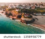 An aerial sunrise view of Newquay beach and town in Cornwall, England.