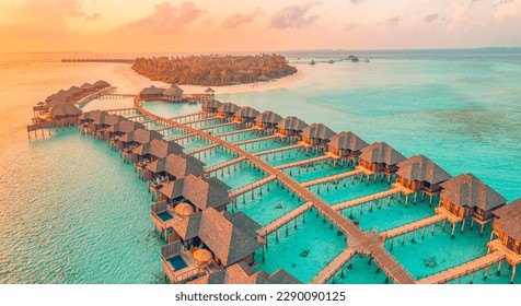 Aerial sunset panoramic landscape luxury tropical resort water villas. Beautiful island beach orange sunrise sea sky. Amazing bird eyes panorama Maldives paradise  tropical bay. Exotic summer vacation - Powered by Shutterstock