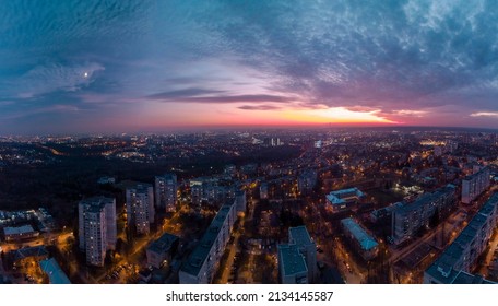 Aerial sunset scenic panorama on Kharkiv city, Pavlove pole. Night lights on streets of residential district and scenic cloudy colorful sky after sunset