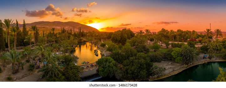Aerial sunset view of the popular summer destination park Sachne or Gan Hashlosha with turquoise water and palm trees in Israel