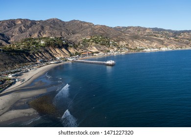 Aerial of Surfrider Beach, Malibu Pier and the Santa Monica Mountains north of Los Angeles in Southern California.