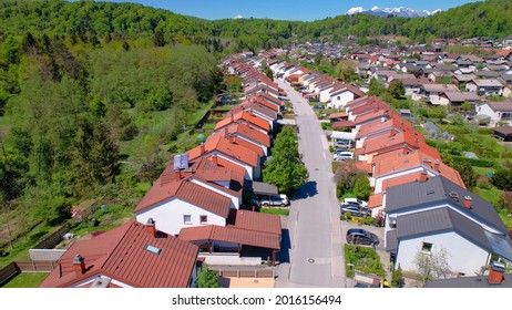 AERIAL: Terraced Houses Sprawl Across The Vast Green Expanse In Slovenia. Scenic Aerial View Of An Idyllic Suburban Neighborhood Near Ljubljana. Flying Above A Quiet Suburbia On A Sunny Summer Day.