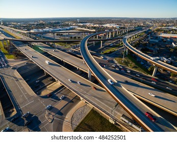 Aerial Texas Hill Country At Sunset Looking Down From Above Highway Interchange And Interstate 35 Running Right Through Austin , Texas With Traffic And Cars Showing Motion