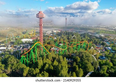 Aerial of a theme park, roller coasters, blue sky, scenic clouds, background, after the storm. Six Flags Magic Mountain Amusement Park Six Flags Hurricane Harbor Valencia   