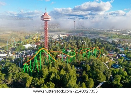 Aerial of a theme park, roller coasters, Sky Tower Ride blue sky, scenic clouds, background, after the storm. Six Flags Magic Mountain Amusement Park Six Flags Hurricane Harbor Valencia   