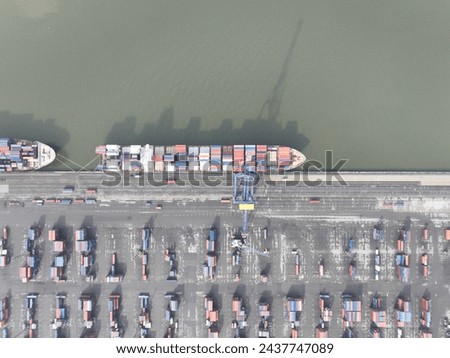Aerial top down of container shipping, port of Antwerp, Belgium. Dock with ships and containers. Merchandise and products for shipping and logistics. Port terminal.