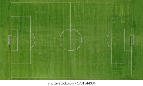Aerial top down drone photo of green football pitch empty to be used for soccer game