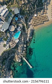 Aerial Top Down Drone Photo Of A Beach Club In Mykonos With Crystal Clear Water In Greece