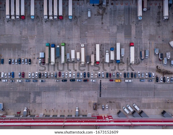 Aerial top\
down drone shot. Cargo truck terminal.\

