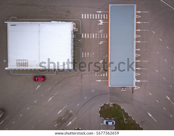 Aerial top down drone\
shot. Gas station. 