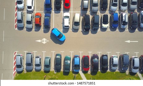 AERIAL TOP DOWN: Flying Above Female Bad Driver Incapable To Park A Car On Parking Space In Crowded Parking Lot. Woman Having Problems, Unable To Park A Car In Parking Spot. Parking Fail On Parkspace