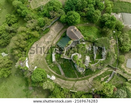 Aerial top down ground plan view of Montaigu le blin Gothic ruin castle in Allier department in Central France. Lower courtyard surrounded by ruined wall, inner castle semi-circular flanking tower