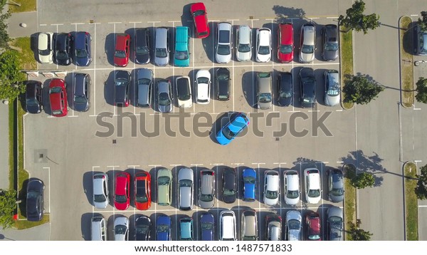 AERIAL TOP DOWN, HYPERLAPSE: Bad driver\
incapable to park a car on parking space in big crowded parking\
lot. Female having problems, unable to park a car in parking spot.\
Parking fail on\
parkspace