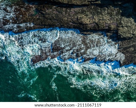 Similar – Aerial Drone View Of Dramatic Ocean Waves Crushing On Rocky Landscape