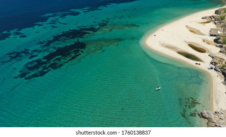 Aerial Top Down Photo Of Beautiful Turquoise Mediterranean Secluded Sandy Bay Forming A Small Peninsula With Only One Colourful Sun Umbrella Enjoying Summer