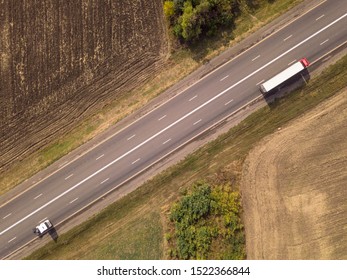 Aerial Top Down Shot Of Highway With Truck Trailer And The Car.