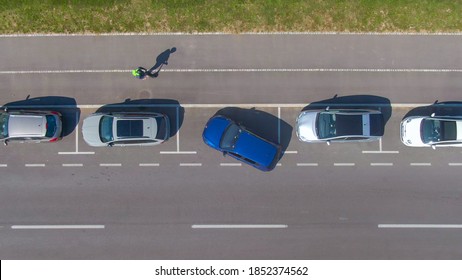 AERIAL, TOP DOWN: Unrecognizable Person Tries To Parallel Park Their Car Into A Tight Roadside Parking Spot. Driver Attempts To Back Their Vehicle Into A Parking Space At The Side Of The Street.