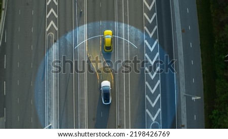 Aerial Top Down View: Autonomous Self Driving Car Moving Through City, Passing Other Vehicles. Scanning Visualization Concept: Artificial Intelligence Digitalizes and Analyzes Road Ahead.