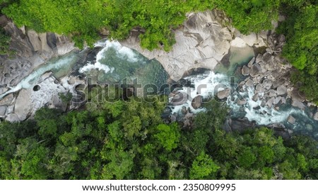 Aerial Top Down view of Babinda Boulders, the tropical rainforest swimming hole and tourist destination situated south of Cairns in Far North Queensland, Australia. 