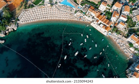 Aerial Top Down View Of Boat Dock And Yacht Port In Montenegro. White Private Motor Boats Are Moored To Pier On Adriatic Sea Coast. Yacht Club Boats Parking. Photo From Drone.