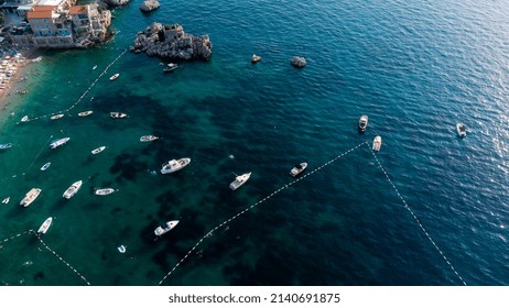 Aerial Top Down View Of Boat Dock And Yacht Port In Montenegro. White Private Motor Boats Are Moored To Pier On Adriatic Sea Coast. Yacht Club Boats Parking. Photo From Drone.