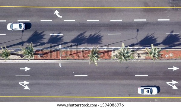Aerial top down view of cars on\
highway road. High altitude view of cars on the expressway\
street.