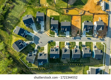 Aerial top down view of cul de sac dead end street with newly constructed single family homes and a home site for new construction at a new residential development in the East Coast USA  - Shutterstock ID 1721344552