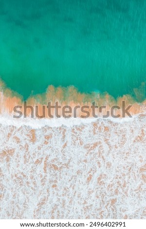 Similar – Luftaufnahme Panoramadrohne Blick auf den blauen Ozean Wellen, die am Sandstrand in Portugal erdrücken.