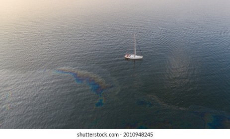 Aerial Top Down View To The Edge Of The Oil Spill Leak Site With The Recreational Yacht Make Way To Pass It Safely On The Tallinn City Area In Baltic Sea, Estonia