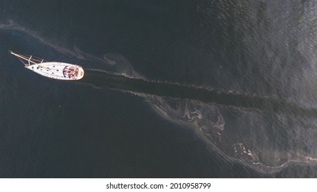 Aerial Top Down View To The Edge Of The Oil Spill Leak Site With The Recreational Yacht Make Way To Pass It Safely On The Tallinn City Area In Baltic Sea, Estonia