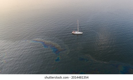 Aerial Top Down View To The Edge Of The Oil Spill Leak Site With The Recreational Yacht Make Way To Pass It Safely On The Tallinn City Area In Baltic